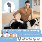 Woman trimming a border collie on the floor while the hose pulls the clippings into the canister