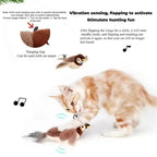 Tabby and white cat swatting the sparrow, close-up of the loop on its neck