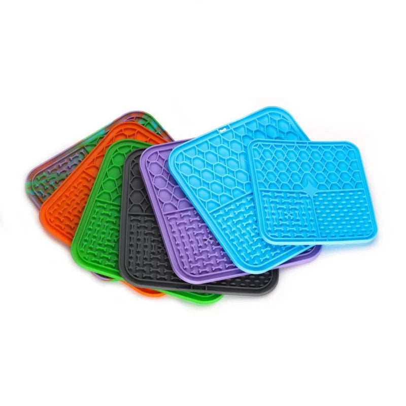 Lick mats fanned out in blue, green, purple, orange, black and a marbled mix