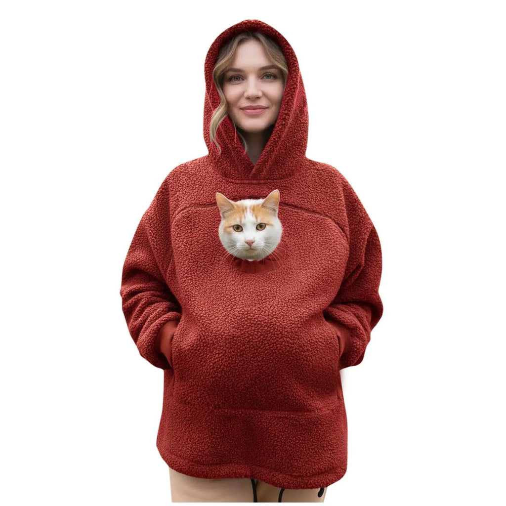 Red hoodie with a cat riding in the front pouch