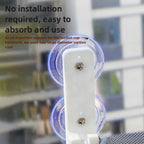 Close-up of a bracket holding two clear suction cups on the glass