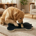 Golden retriever digging at the bone-shaped board on a rug to reach the treat drawer