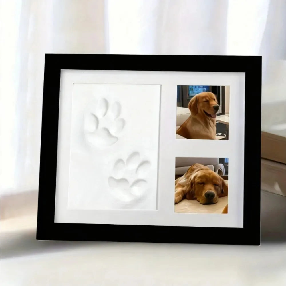 Black frame with a white clay paw print and two dog photos