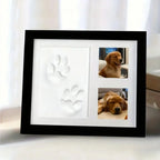 Black frame with a white clay paw print and two dog photos