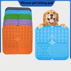 Golden retriever holding a blue lick mat, and a stack of mats in five colors